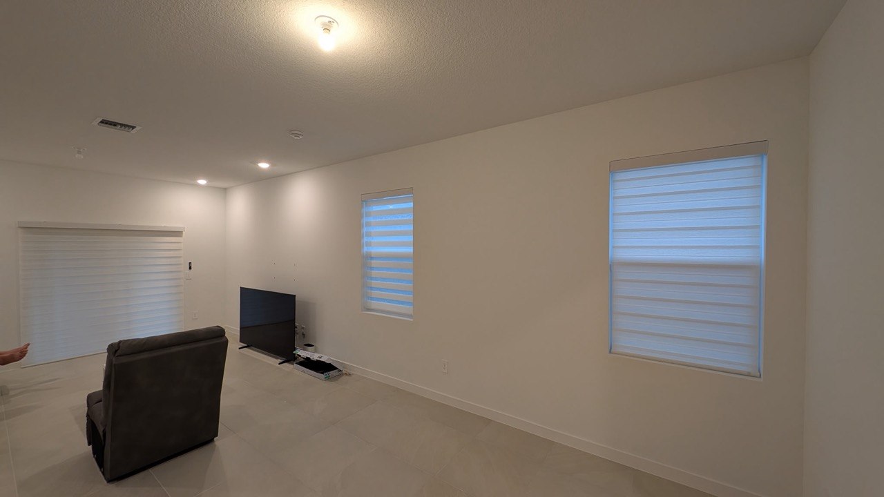 Motorized zebra shades installed in Pompano Beach living room