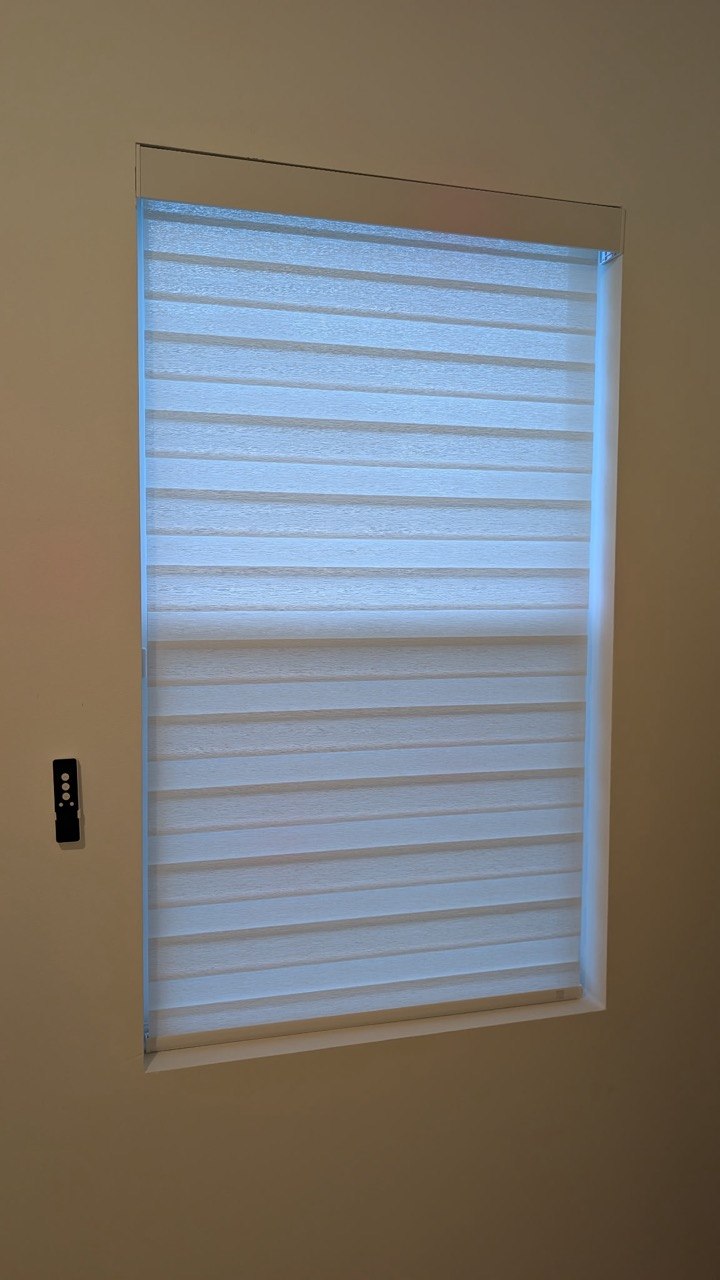 Motorized zebra shade with wall-mounted remote in Pompano Beach