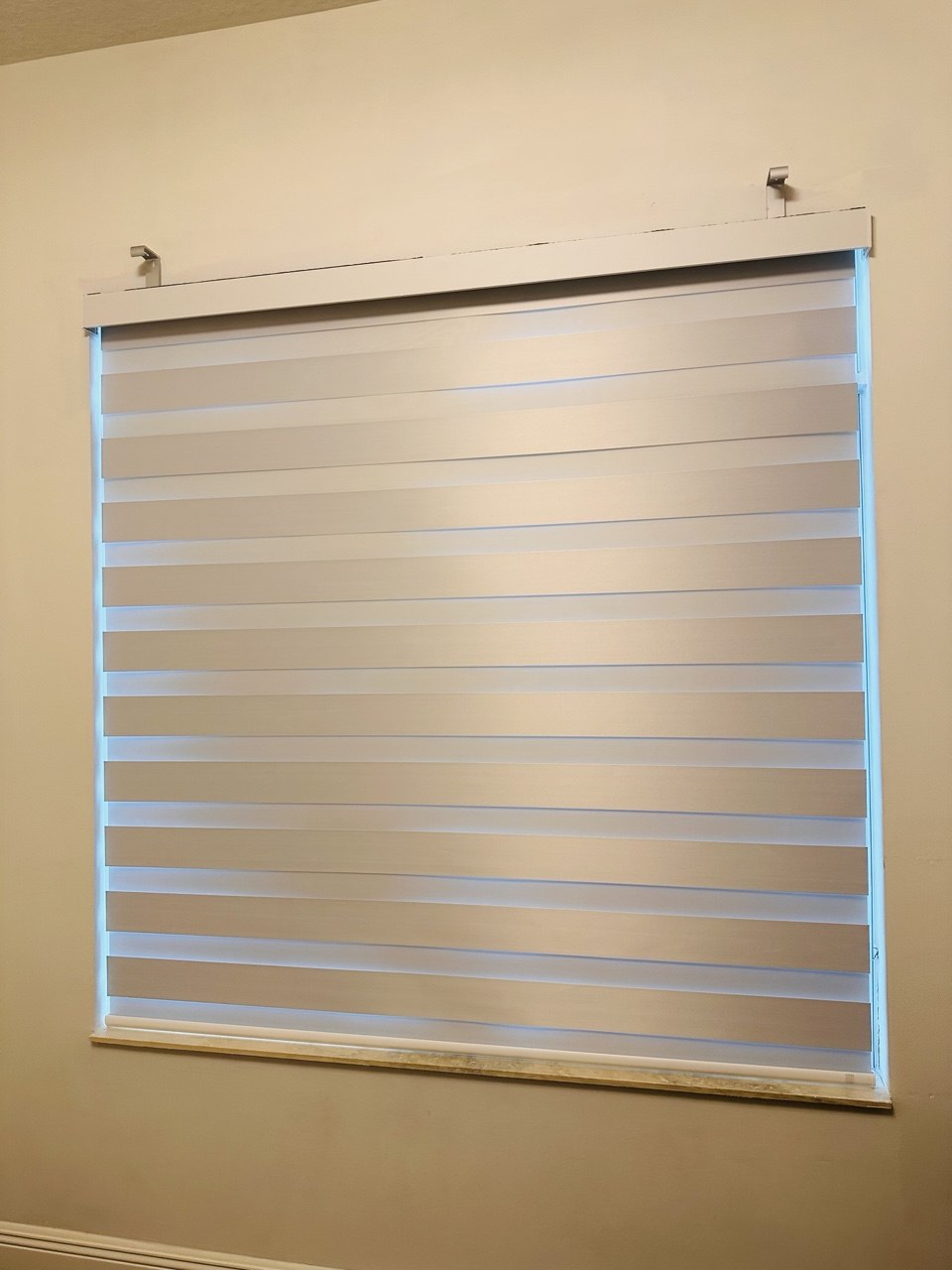 White motorized zebra blackout shade on a Delray Beach bedroom window