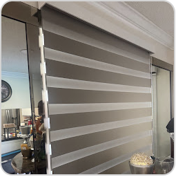 Close-up of layered zebra blind fabric on a window