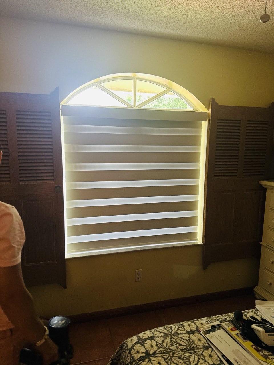Motorized zebra shade installed on bedroom window in Miami home remodel