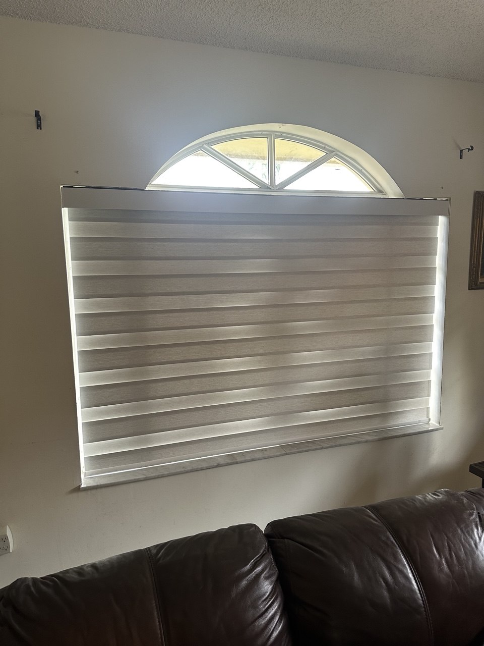 Motorized zebra shade partially raised in Miami home