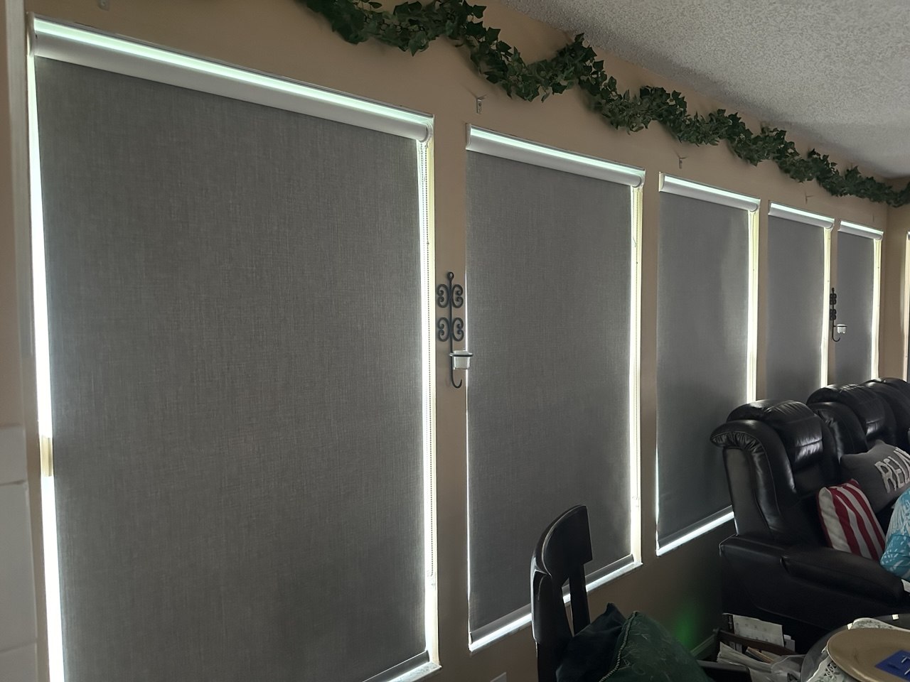 Custom blackout roller shades covering a series of Royal Palm Beach windows