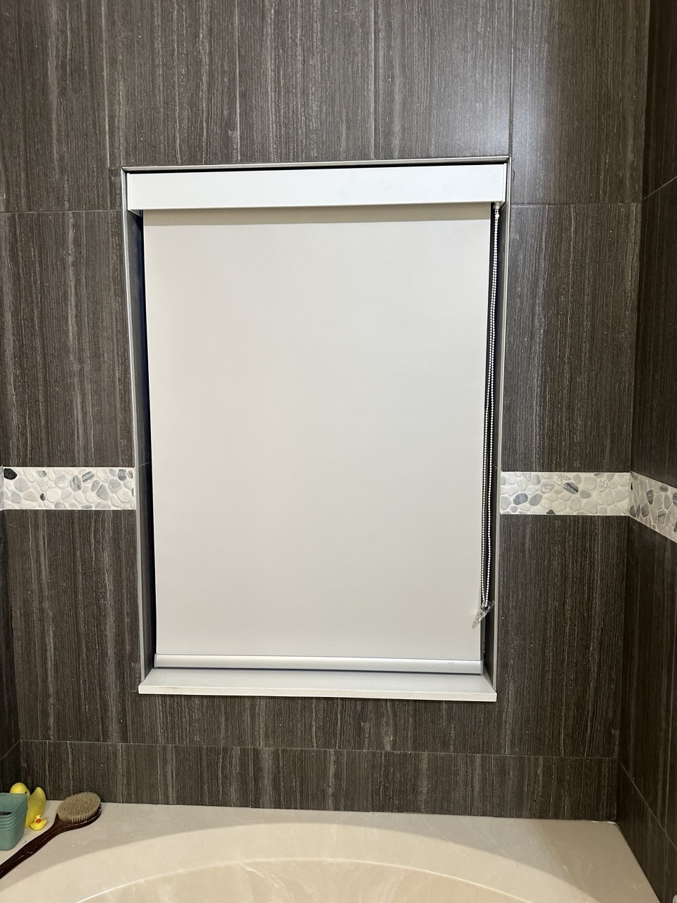 Finished custom roller shade in a Fort Lauderdale bathroom