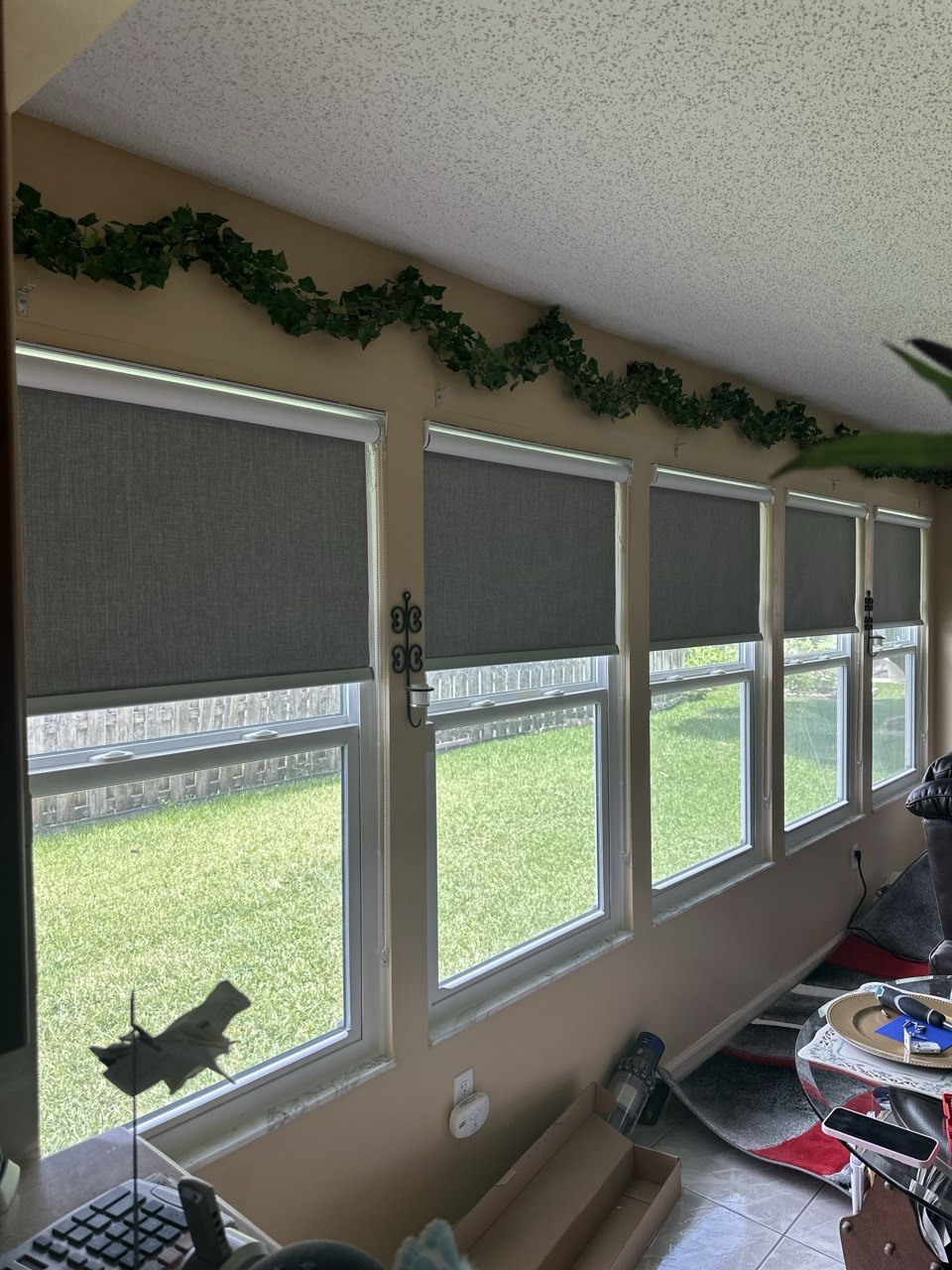 Blackout roller shades partially raised over multiple windows in Royal Palm Beach