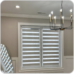 White zebra blinds installed on a dining room window