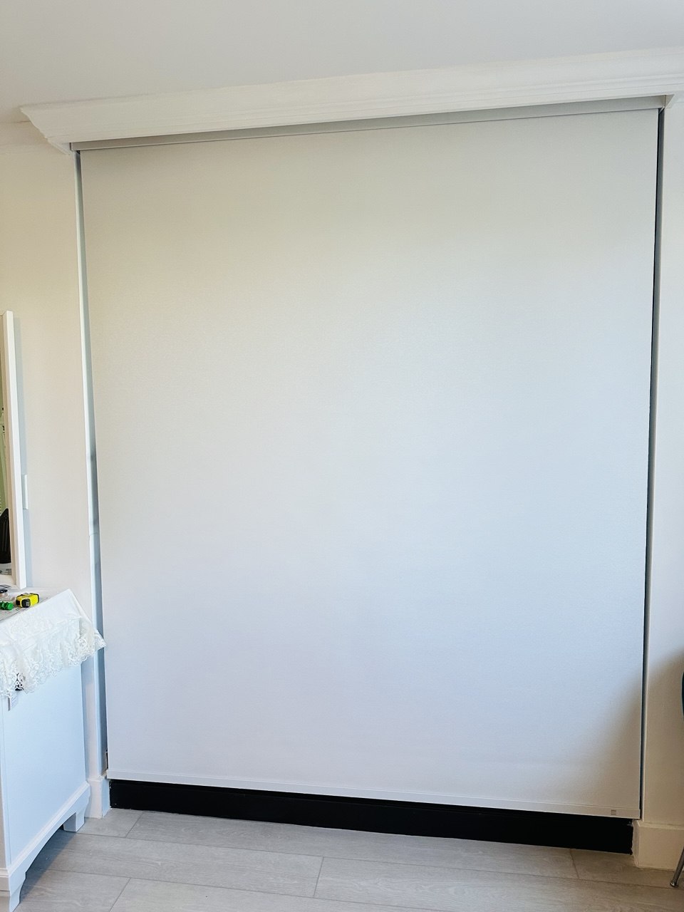 Motorized roller shade fully closed in a Boca Raton condo bedroom