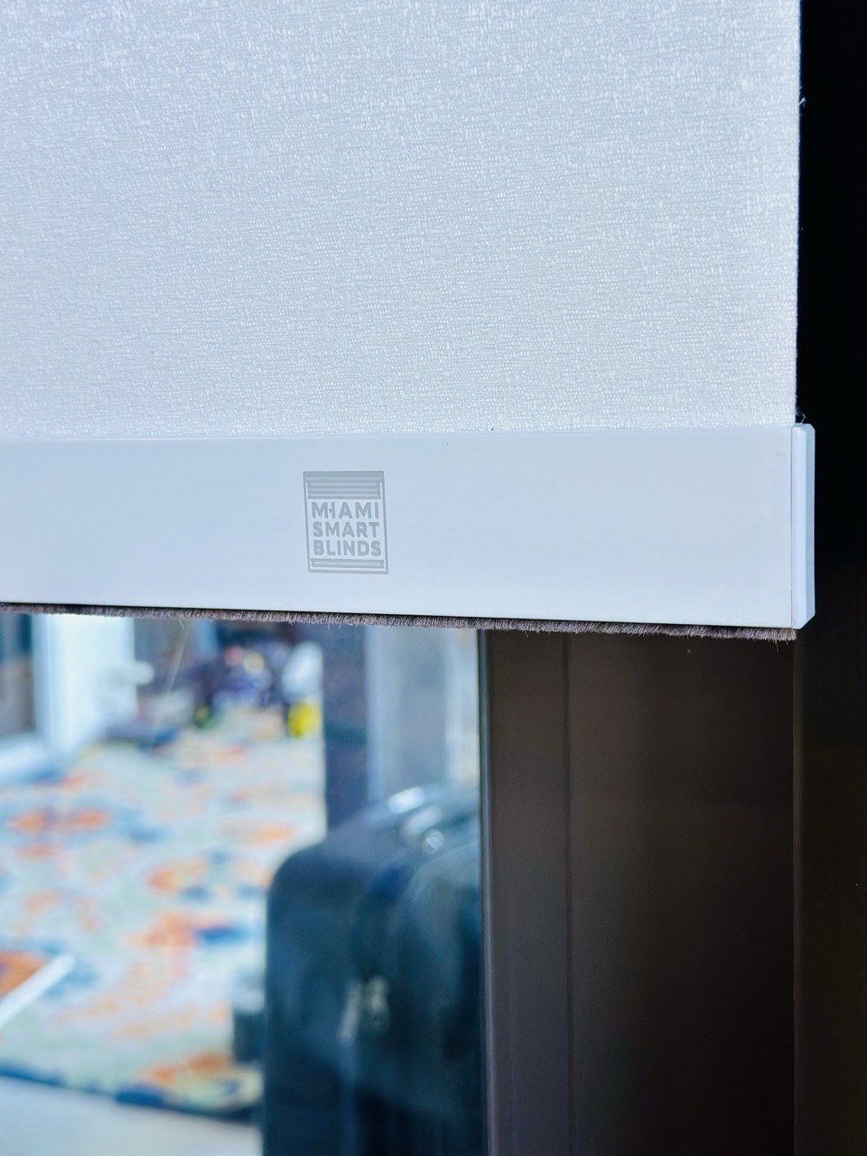 Miami Smart Blinds branded bottom bar on a motorized roller shade
