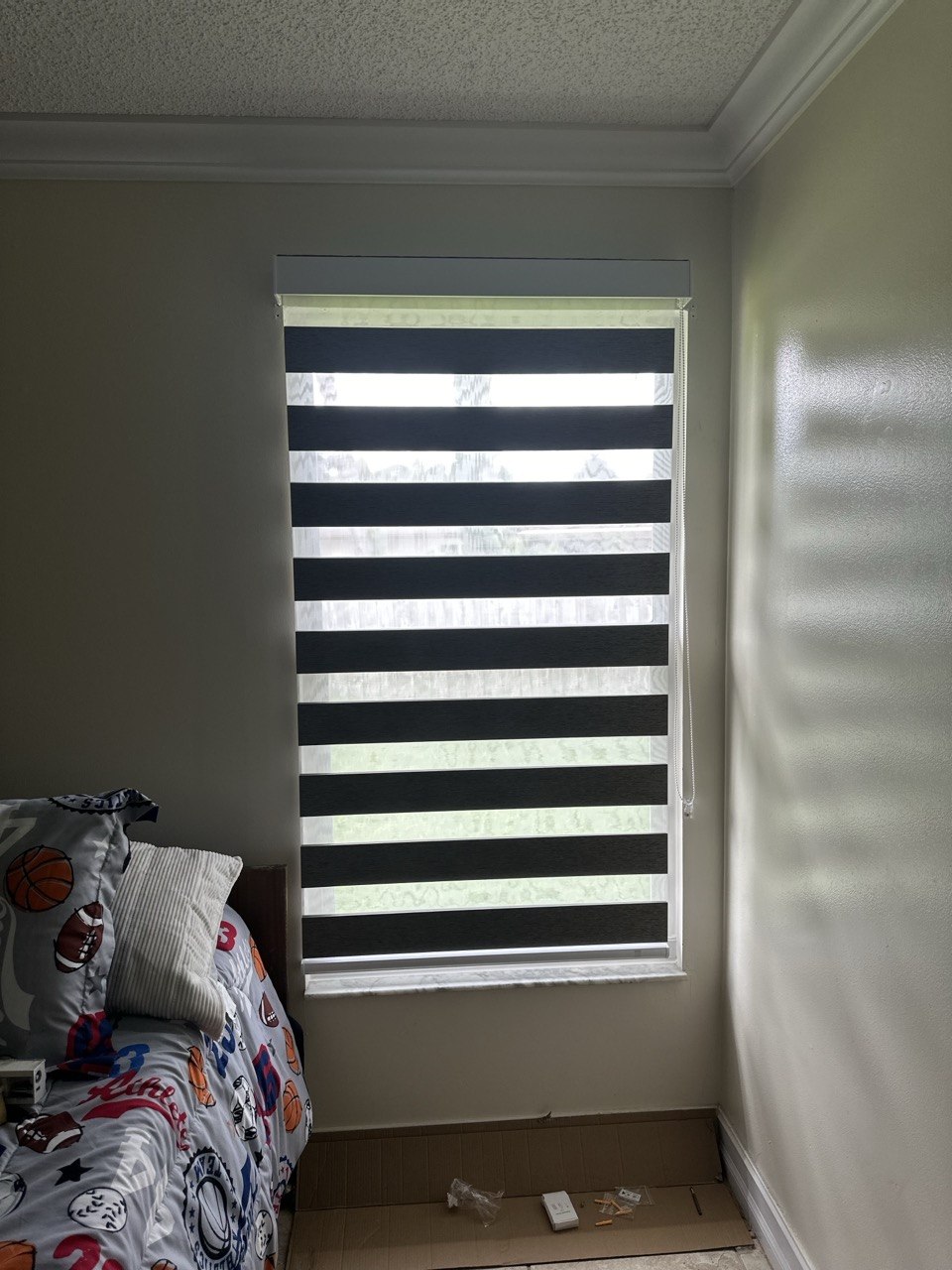 Zebra shade with sheer bands aligned on a bedroom window in Royal Palm Beach