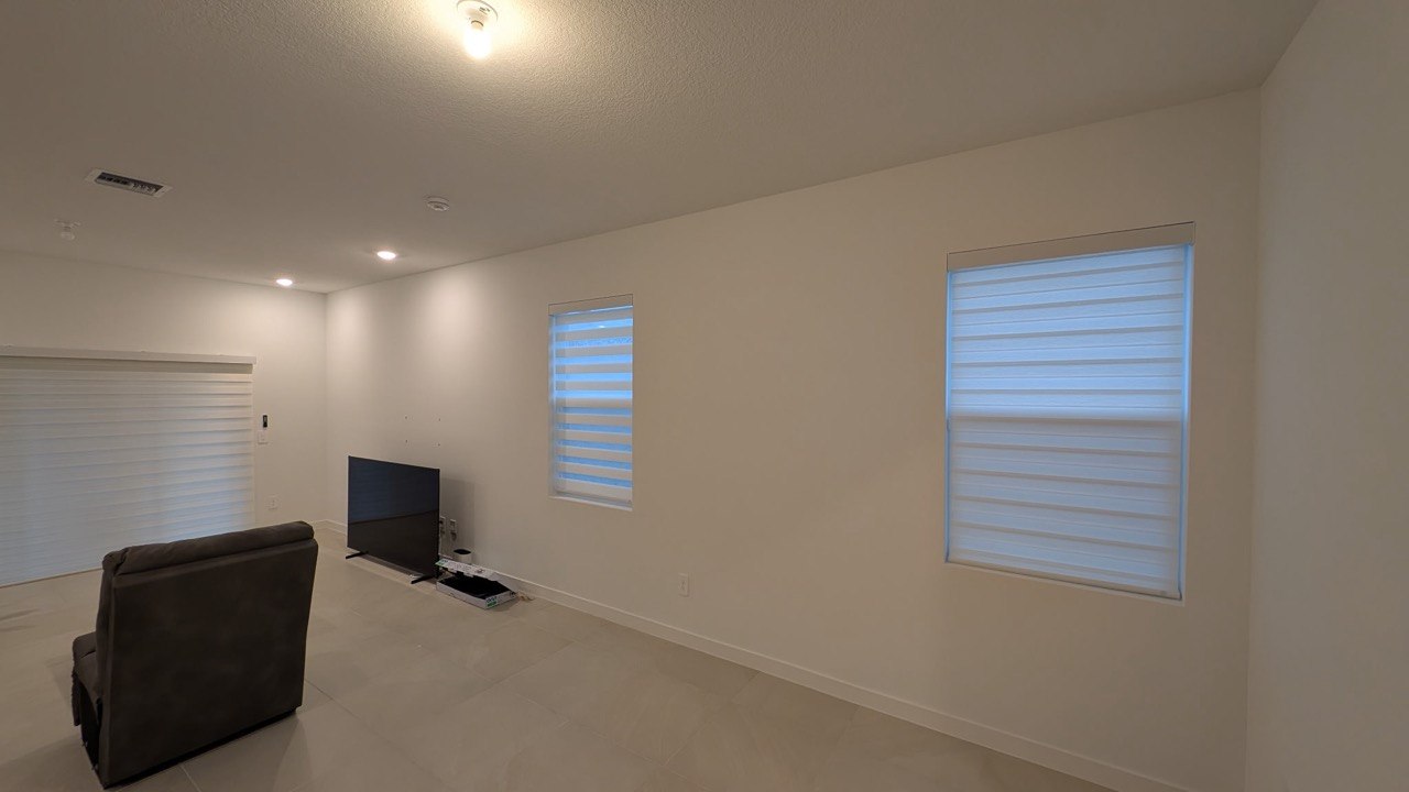 Pompano Beach living room with three motorized zebra shades