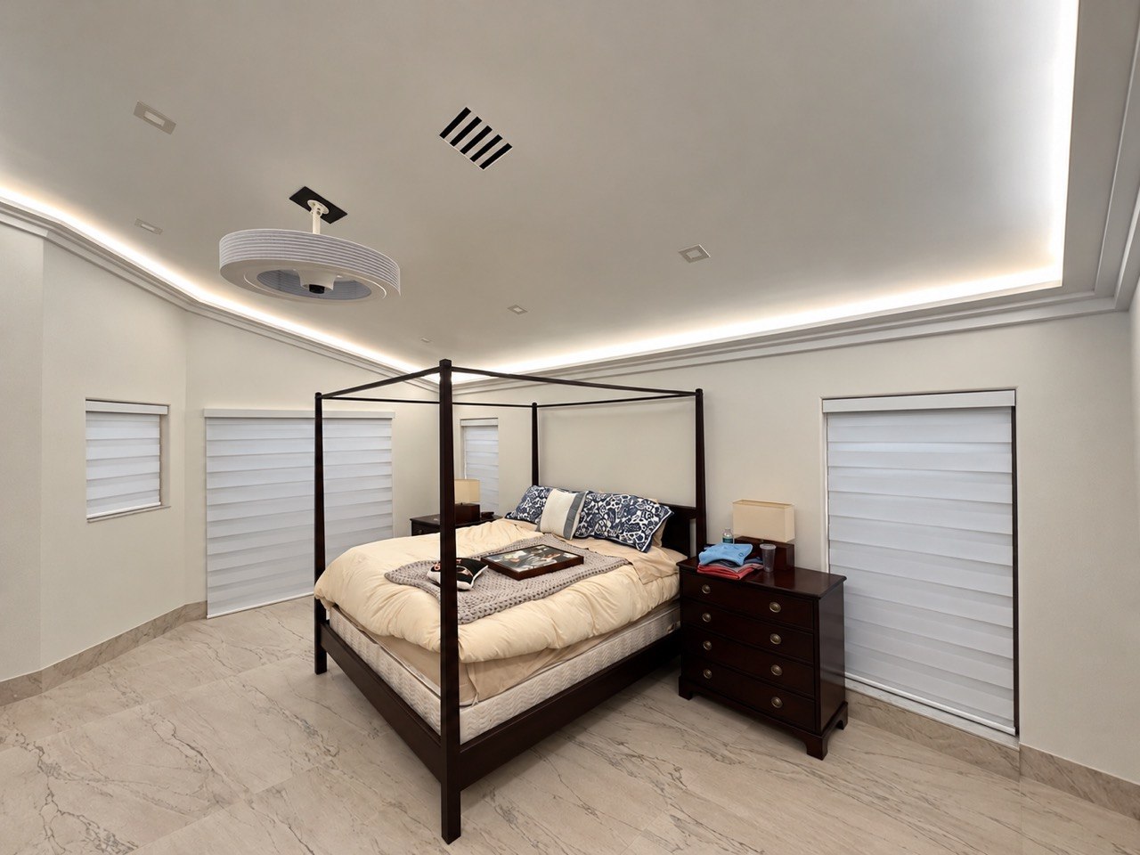 Finished Fort Lauderdale bedroom with a four-poster bed and four installed motorized zebra shades