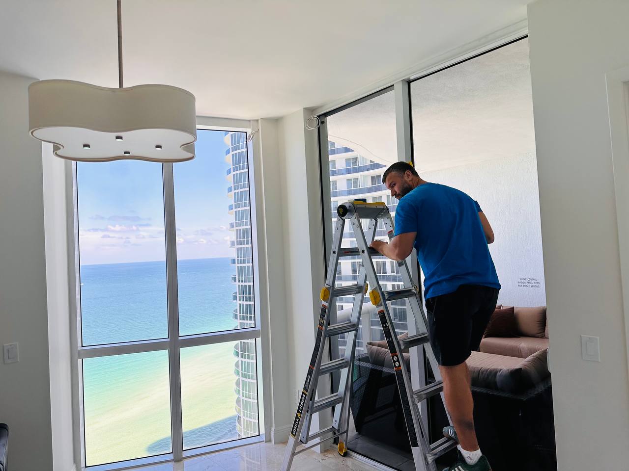 Miami Smart Blinds installing motorized Shangri-La shades in a Miami apartment