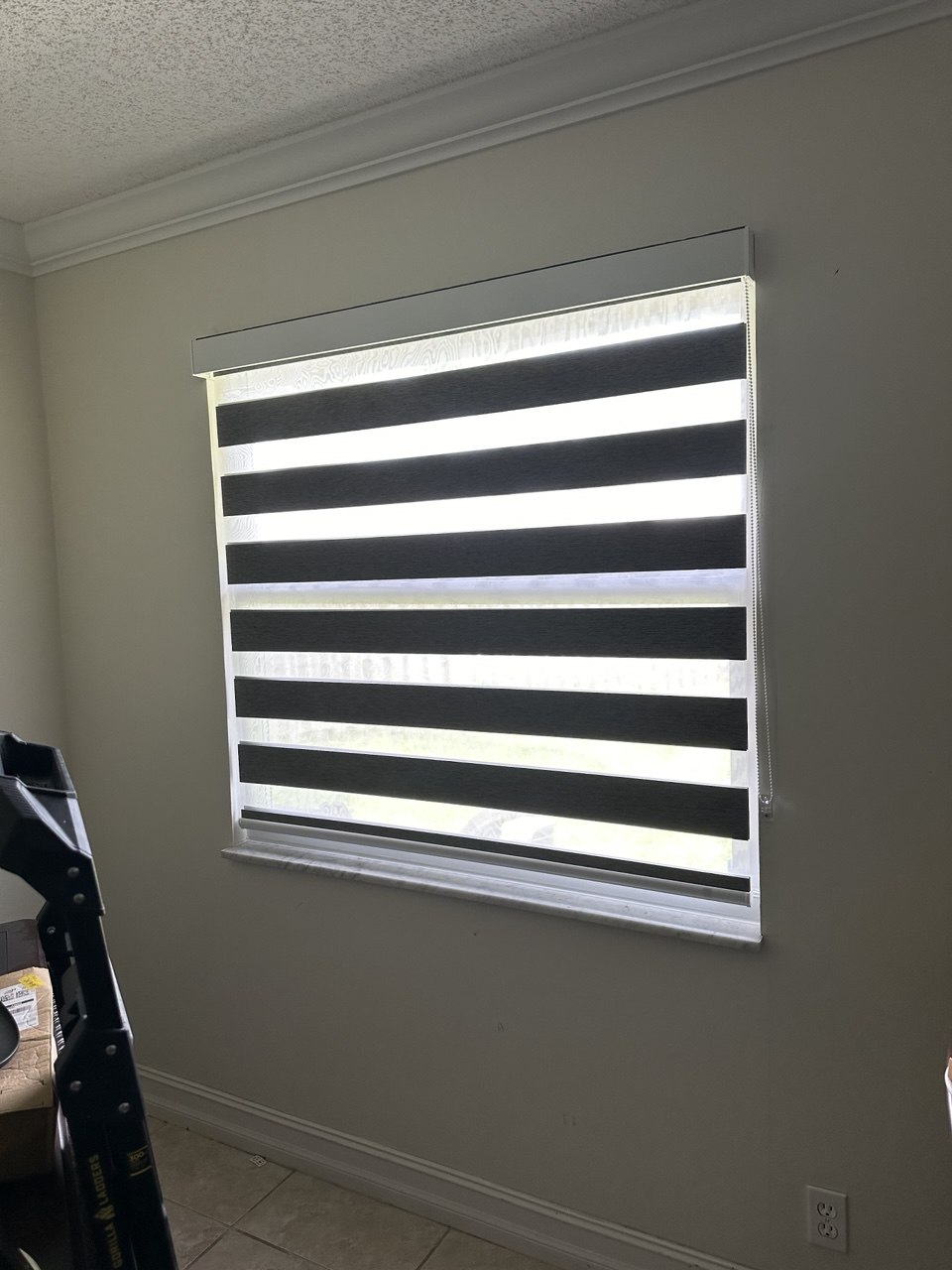 Wide zebra shade open for filtered daylight in a Royal Palm Beach home