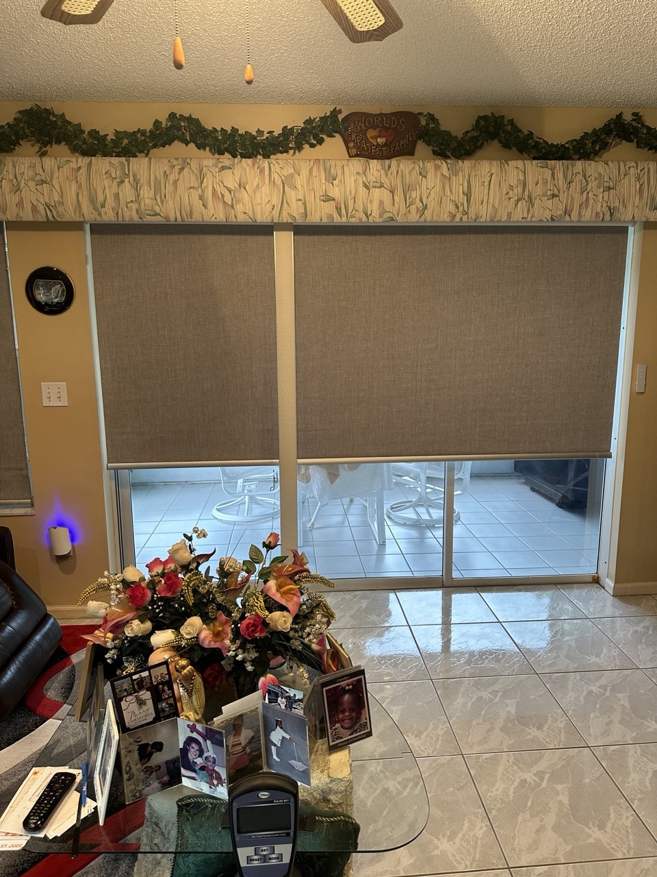 Blackout roller shades installed over a large sliding glass door in Royal Palm Beach