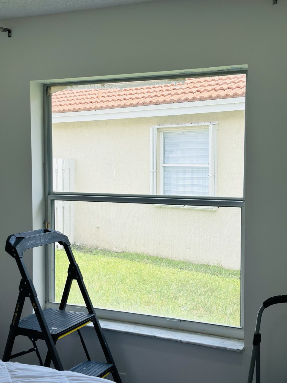 Bedroom window before custom zebra shade installation in Fort Lauderdale