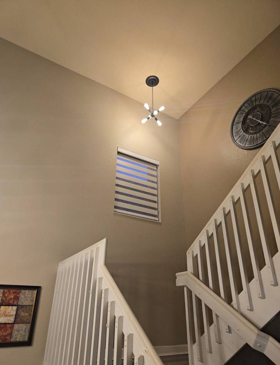 Zebra shade on a stairwell window in a Kendall house
