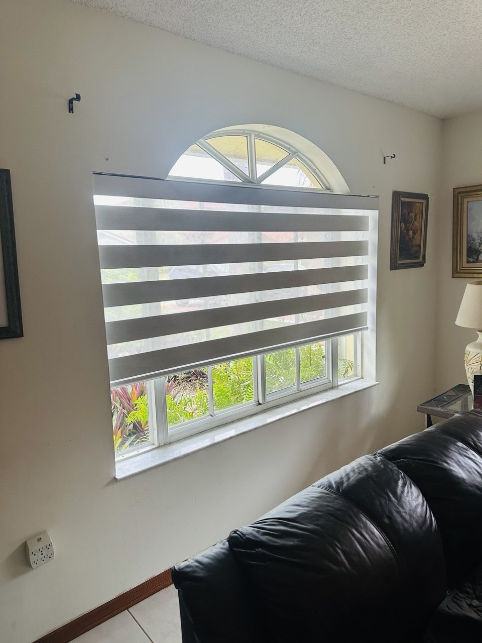 Motorized zebra shade in open light-filtering position in a Miami home