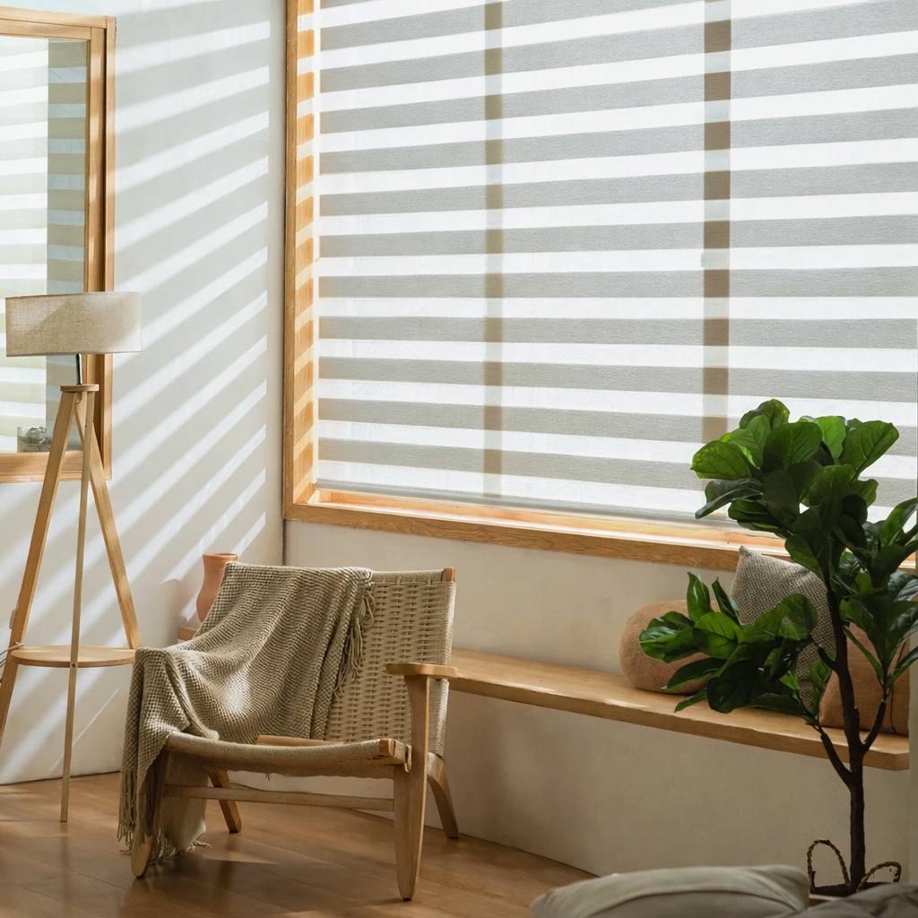 Sand-coloured zebra shades on corner windows in a sunlit living room